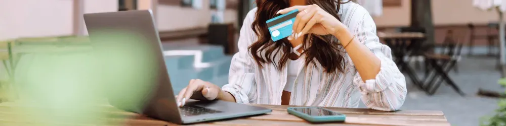 Young woman use credit card on travel website.